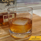 Whiskey glass with large ice cube and whiskey