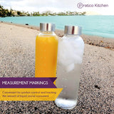 clear glass juice containers with measurement markings